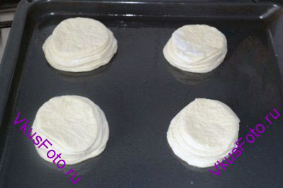 На смазанный маслом противень расставить булочки, оставляя между ними большое расстояние, т.к. они увеличатся в объеме. Противень накрыть полотенцем и поставить в теплое место на 45 минут.